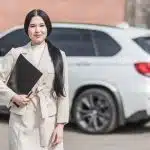 Woman in Beige Corporate Clothes Holding Black Folder
