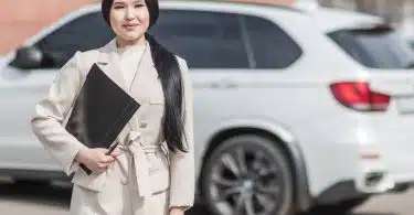 Woman in Beige Corporate Clothes Holding Black Folder